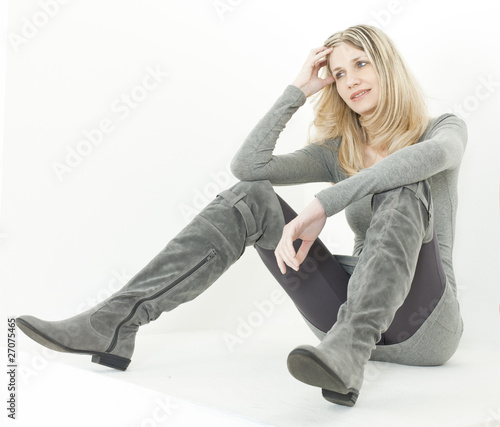 sitting woman wearing fashionable gray boots