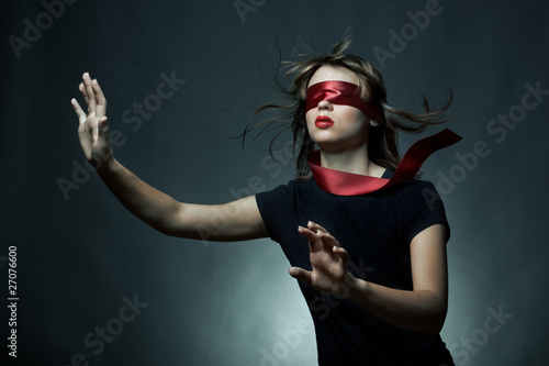 Portrait of the young woman blindfold photo