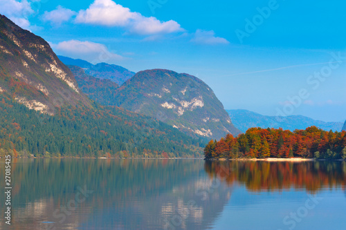 Autumn forest, lake and mountains. Bohinj lake, Slovenia