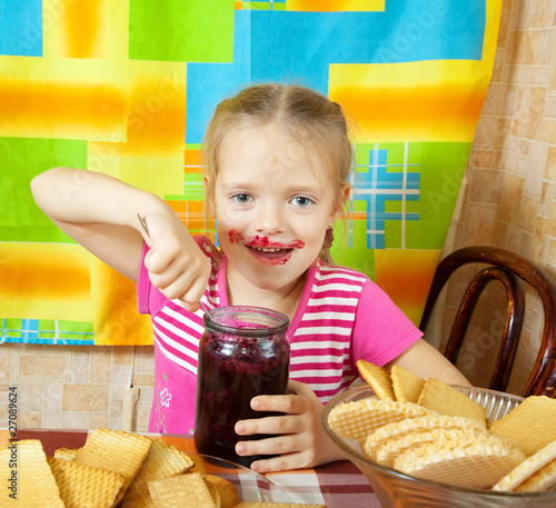 Little girl eating marmalade photo