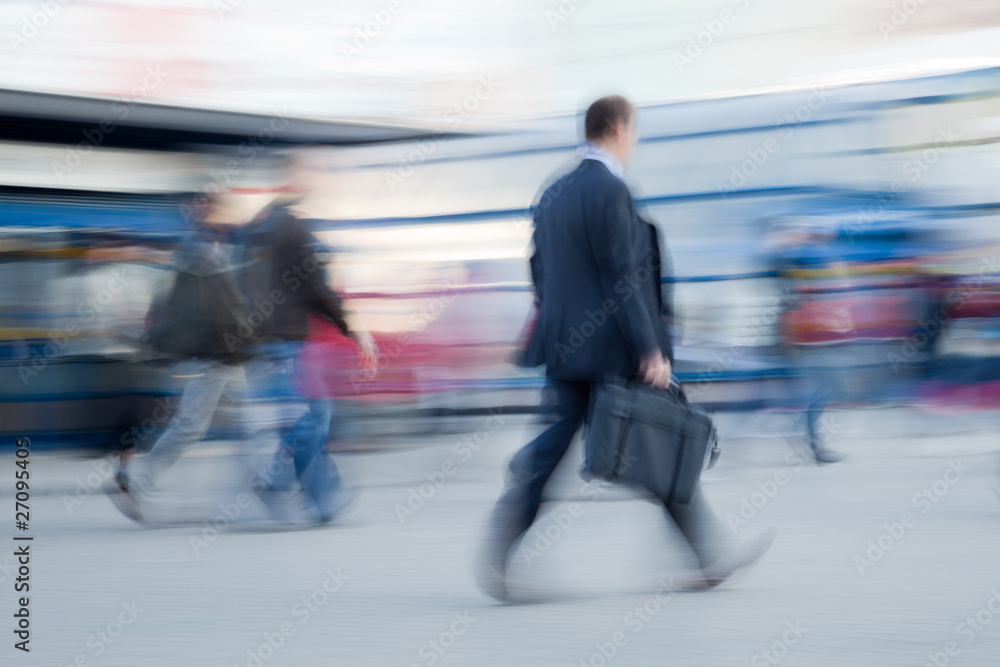 Blurred image of businessman rushing to office