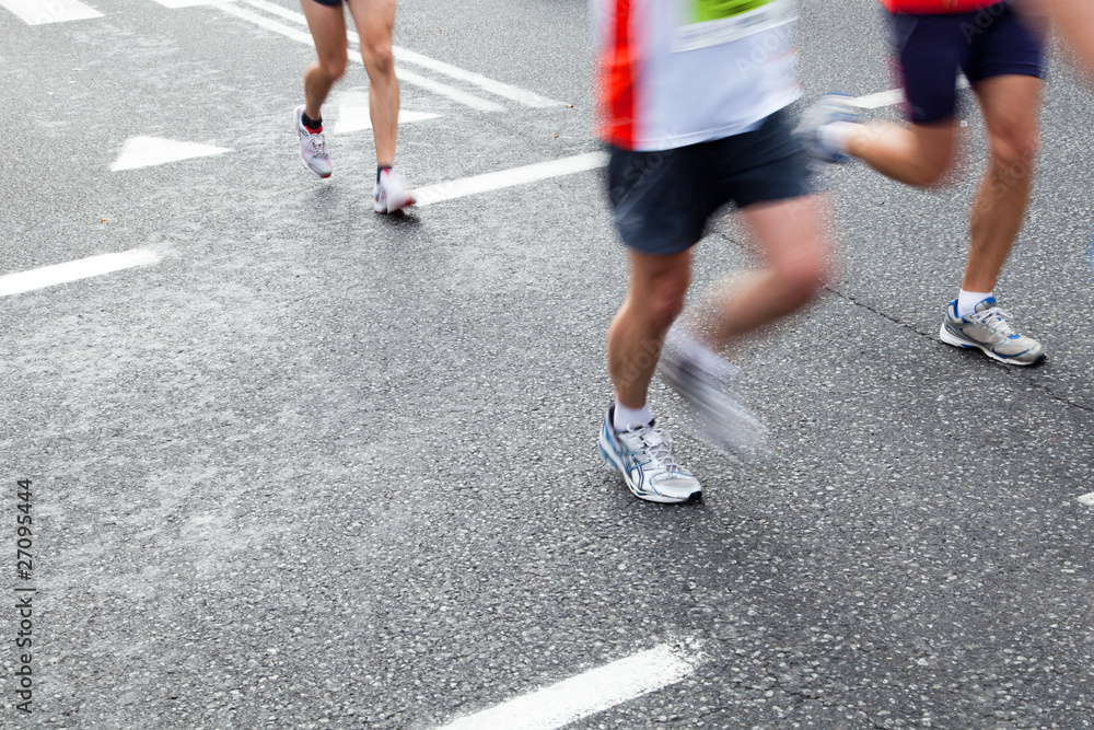 People running in city marathon