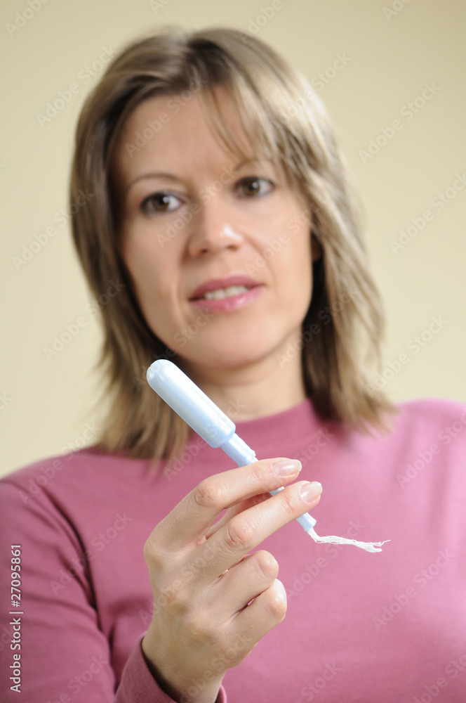 woman showing applicator for mesntrual period woman showing applicator for mesntrual period