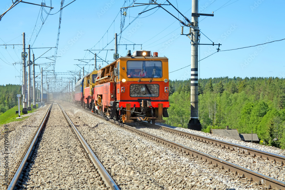 Red-orange trolley does run on railway tracks in the summer