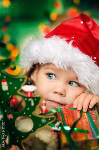 Happy small girl in santa hat have a christmas