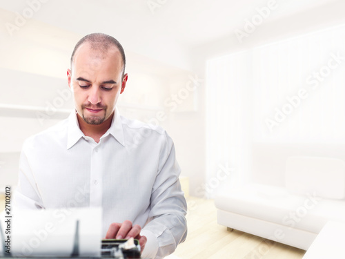 man with typewriter at home
