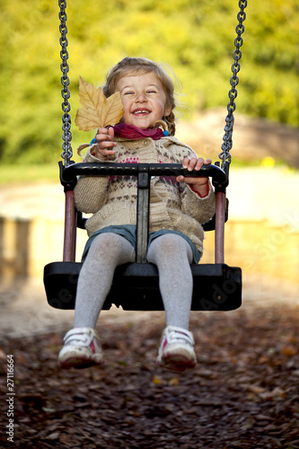 little happy girl on the swing photo