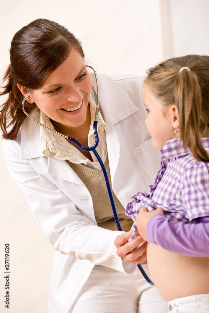 Female doctor examining child with stethoscope Female doctor examining child with stethoscope