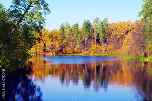 Picturesque autumn landscape of river and boat