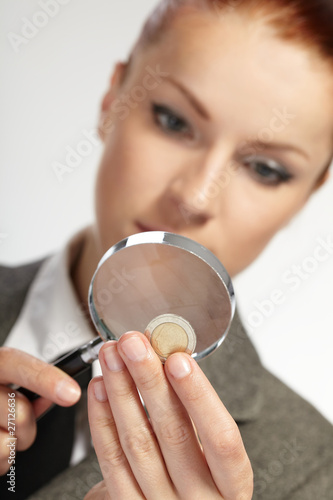 portrait of young businesswoman with magnifying glass