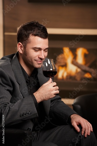 Man tasting wine at home