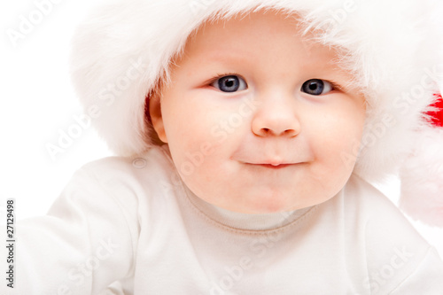 Baby in a large Santa hat