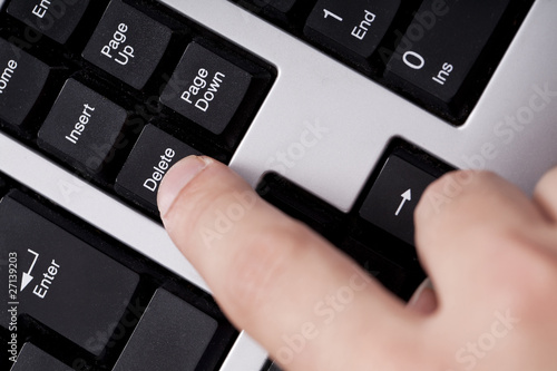 finger pressing delete key