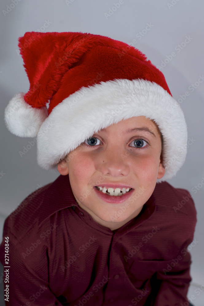 close up of boy with santa hat close up of boy with santa hat
