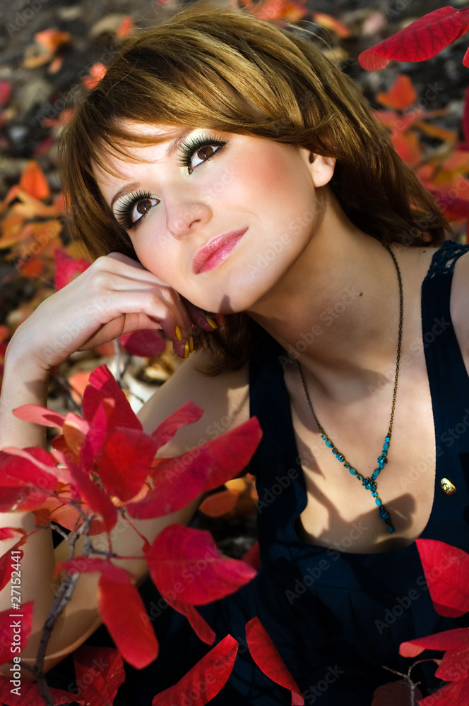 Naklejka premium The girl in autumn wood