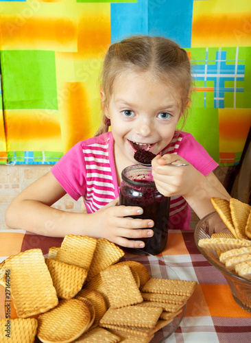 Little girl eating jam photo