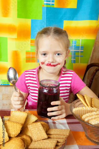 Little girl eating marmalade photo