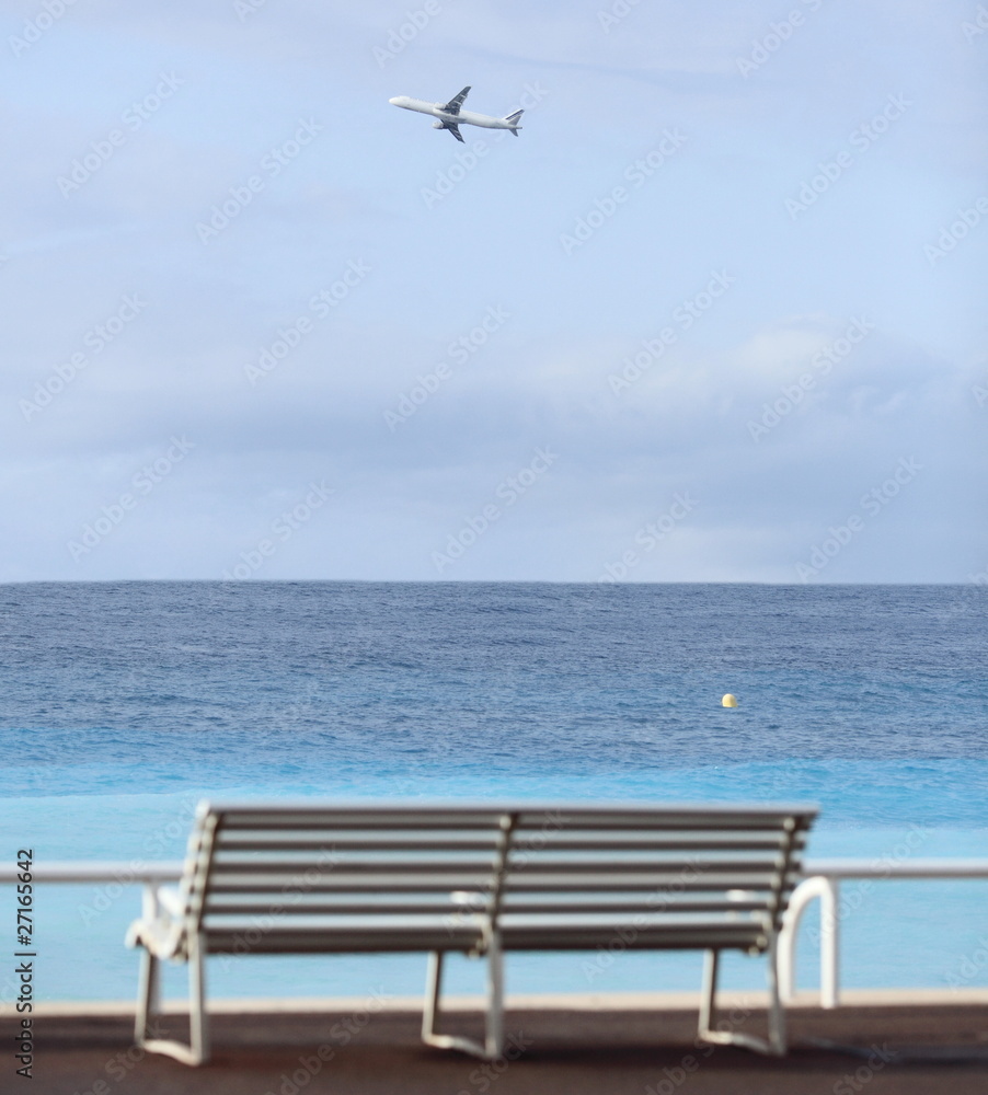Promenade des Anglais in Nice, France (bench and an airplane)