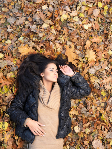 Beautiful woman spending time in park during autumn season