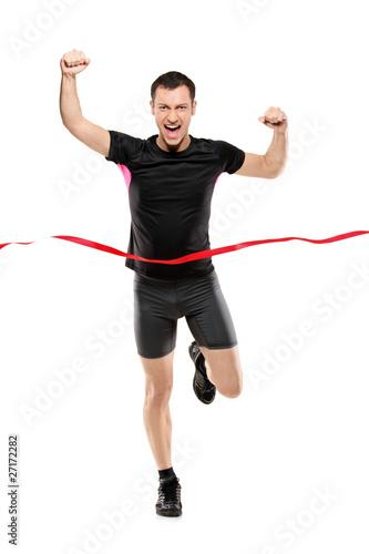 Full length portrait of a young runner at the finish line