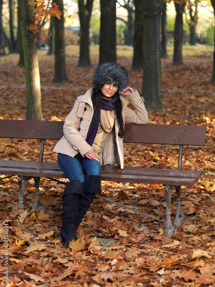 Beautiful woman spending time in park during autumn season