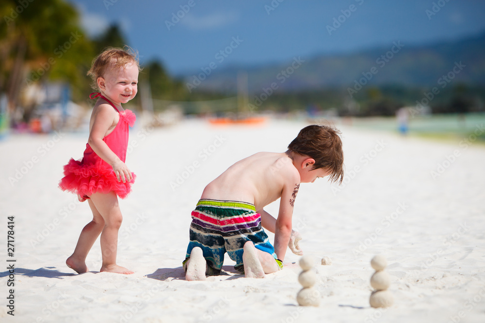 Two adorable kids standing by ocean shore Two adorable kids standing by ocean shore