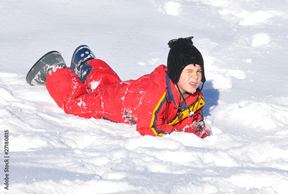 sport d'hiver enfant garçon couché dans la neige poudreuse Stock Photo