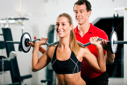 Woman with Personal Trainer in gym