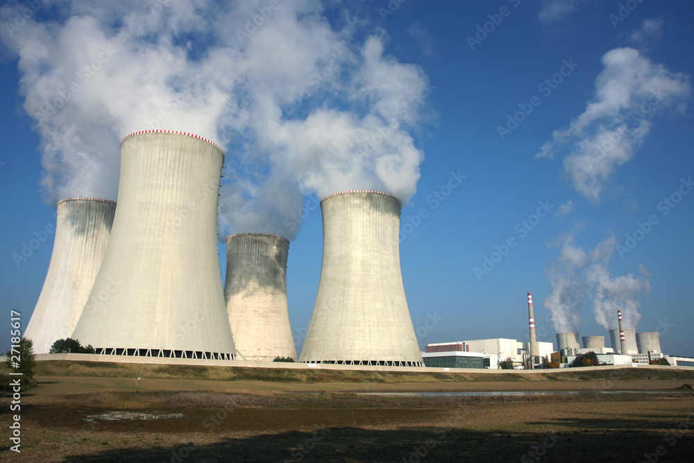 smoking power plant in agriculture field under blue sky smoking power plant in agriculture field under blue sky