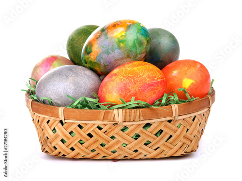 Colored easter eggs in a basket isolated