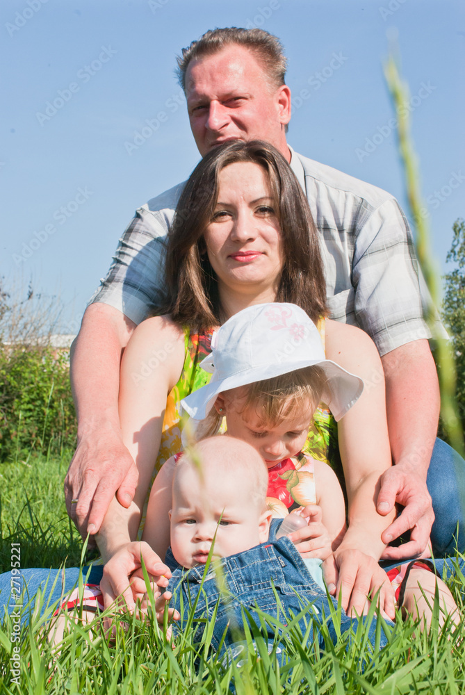 a happy family on the lawn, against the sky a happy family on the lawn, against the sky
