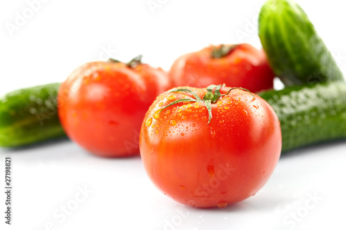 fresh tomatoes and cucumbers on the white background
