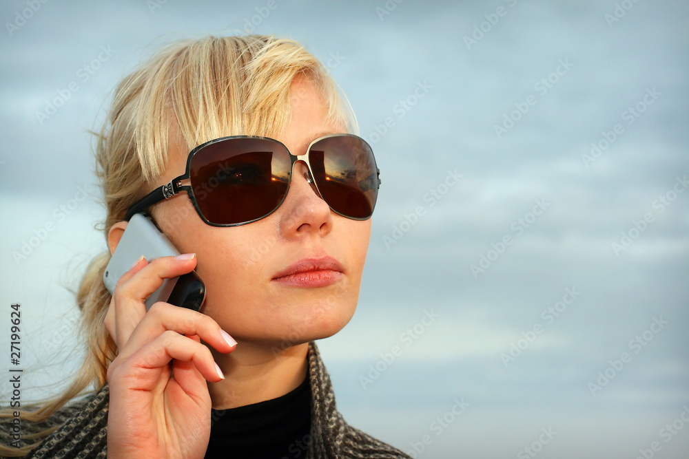 Blond young girl on background blue sky Blond young girl on background blue sky