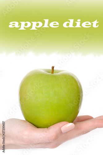 Green apple in a beautiful hand of woman