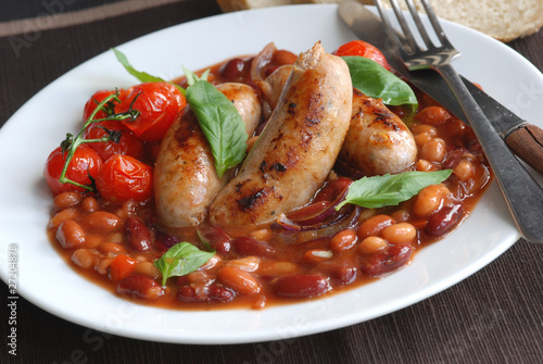 Sausages with mixed beans and tomatoes