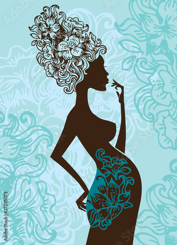 Silhouette of pregnant woman in flowers