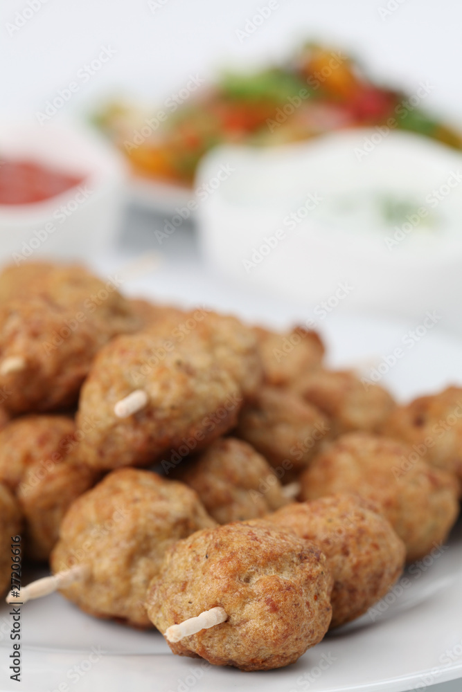Roast meatballs with tzatziki and tomato dip and salad Roast meatballs with tzatziki and tomato dip and salad