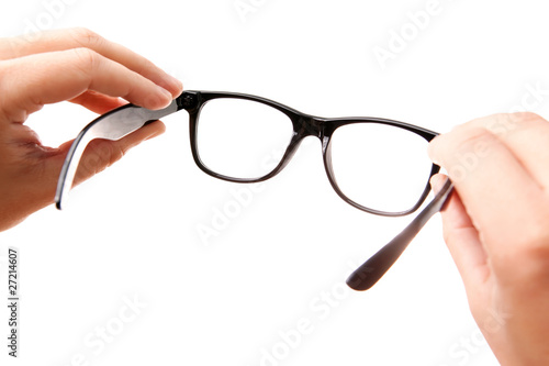 Hands holding classic-styled glasses