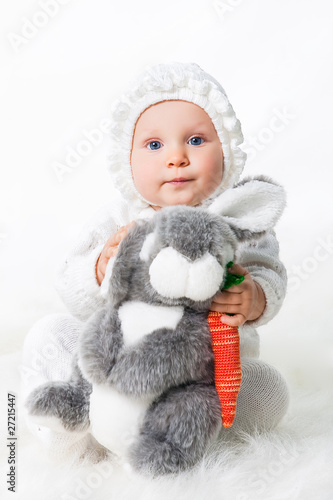 little infant smiling girl with rabbit and parrot