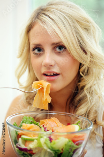 Teenage Girl Eating Smoked Salmon Salad. Model Released