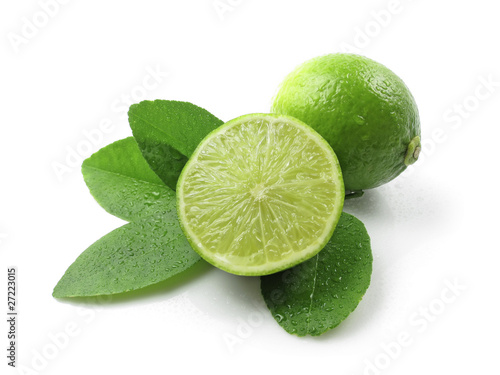 Green lemons with leaves on white background