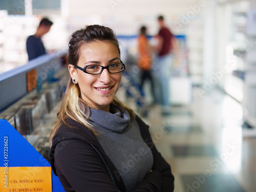 Obraz na plátně portrait of salesgirl in cd store