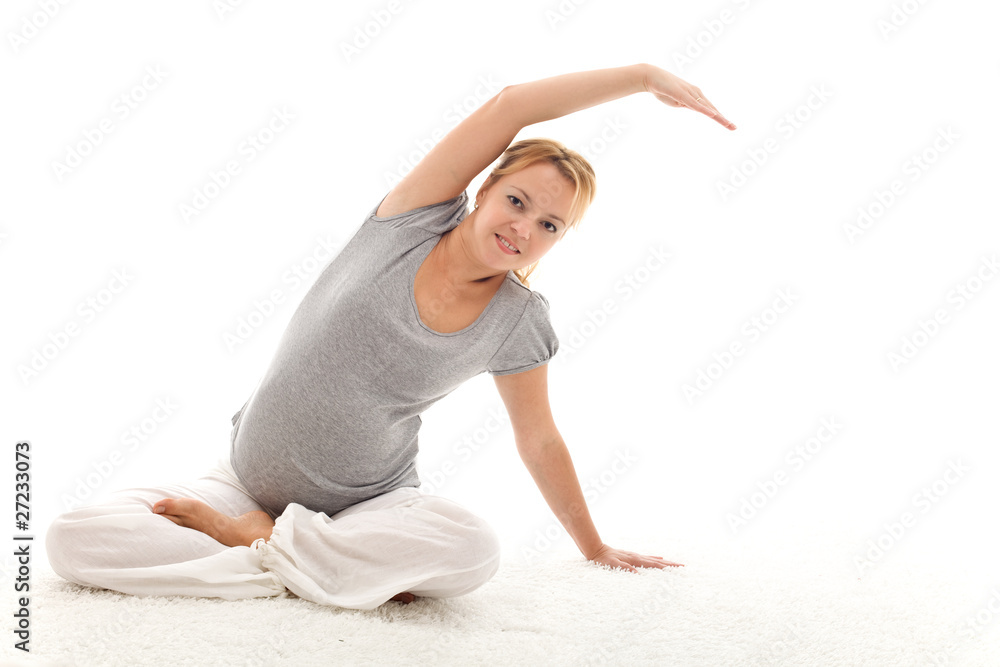 Beautiful pregnant woman doing stretching exercises Beautiful pregnant woman doing stretching exercises