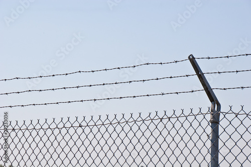 Chain Link Fence Topped with Barbed Wire