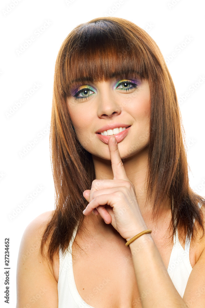 Young girl with her finger over her mouth Young girl with her finger over her mouth