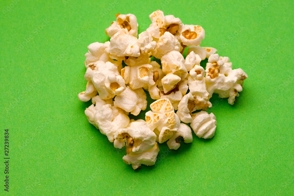 Popcorn isolated on green Popcorn isolated on green