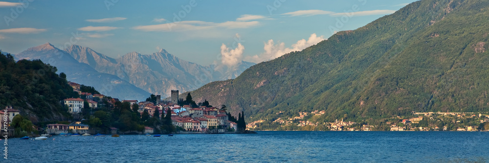 Lago di Como coastline town with mountains in background.