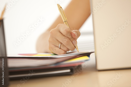 Close-up of businesswoman writing