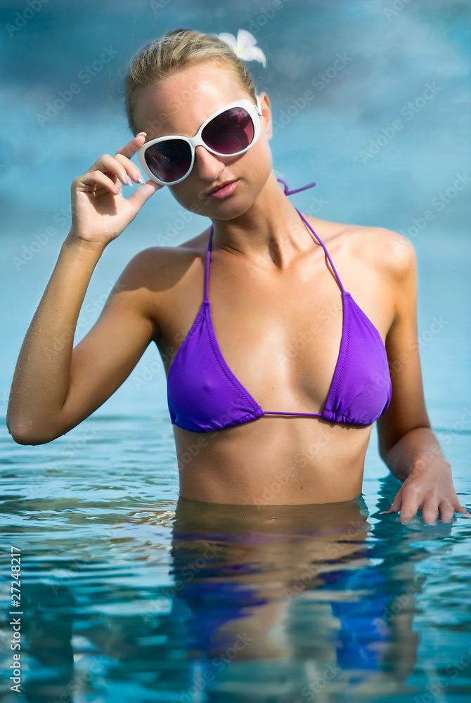 Beautiful girl relaxing in shiny blue water Beautiful girl relaxing in shiny blue water