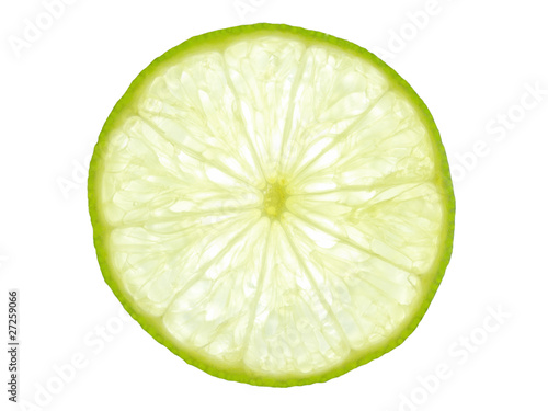 Green lemon slice backlit on white background